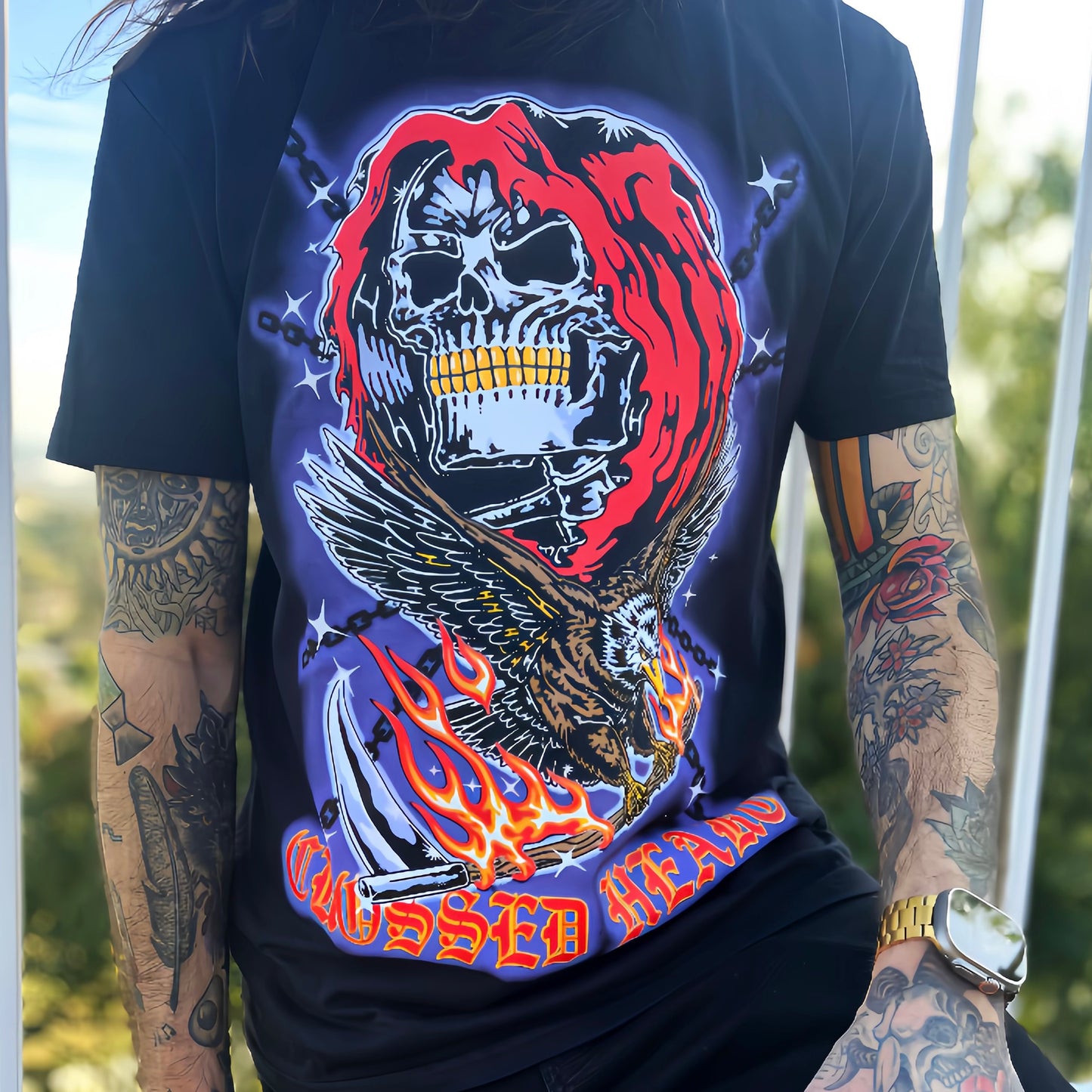 Model wearing black tattoo-inspired skull graphic alternative streetwear t-shirt with eagle and flames by Crossed Heart Clothing