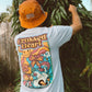 Person wearing white alternative streetwear t-shirt with colorful skull and butterfly back graphic by Crossed Heart Clothing outdoors