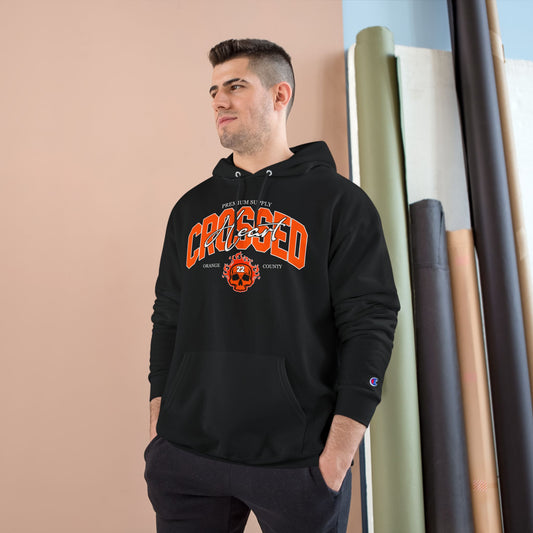 model wearing black chc premium supply champion hoodie with orange county skull graphic front print streetwear pullover lifestyle photo