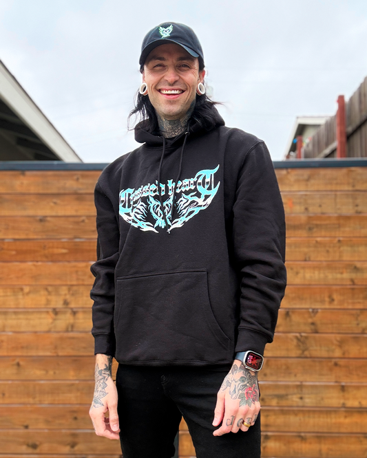 person wearing black hoodie with teal crossed heart lightning logo graphic front print streetwear lifestyle photo