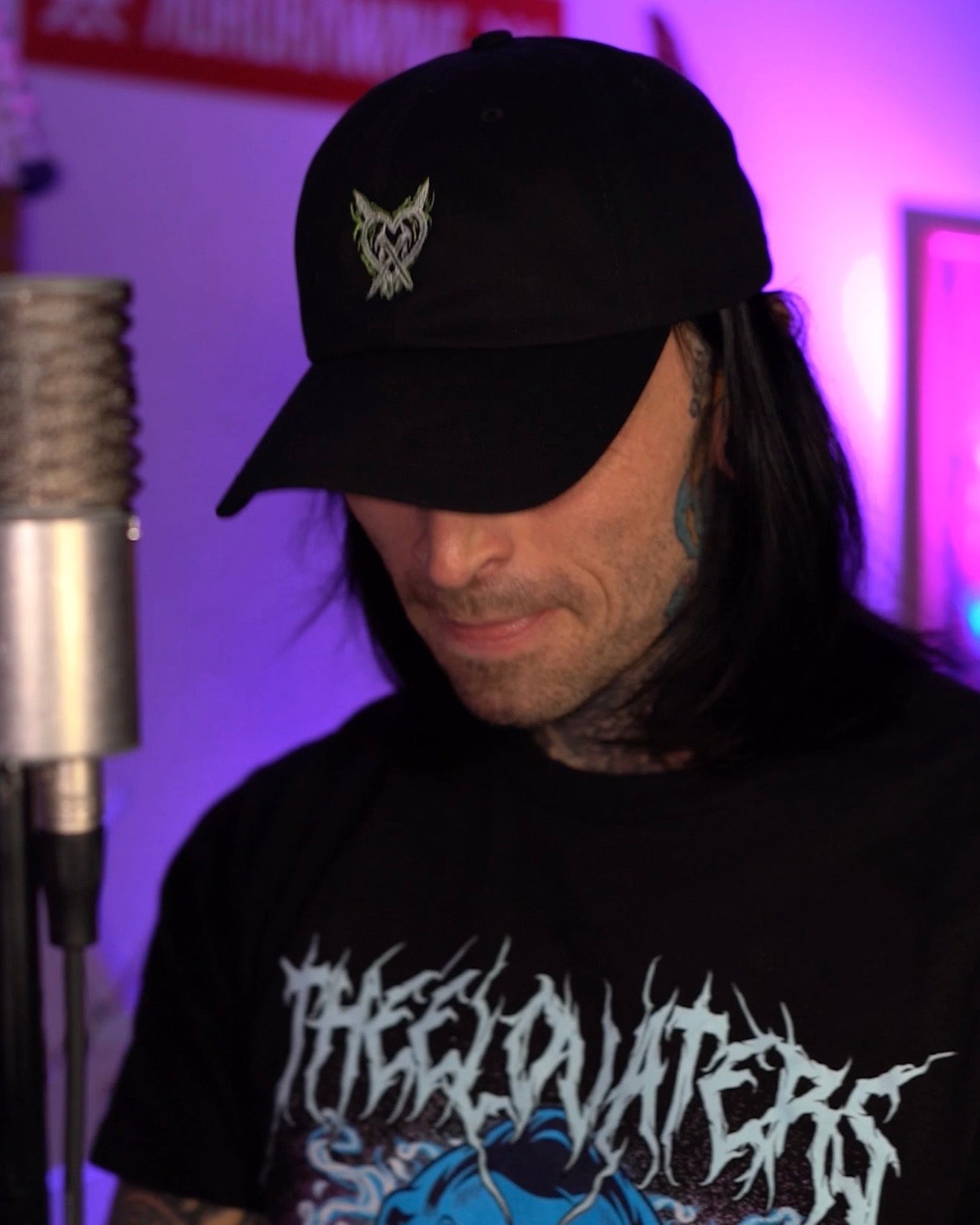 person wearing black lightning heart dad hat with green embroidered heart logo crossed heart clothing streetwear lifestyle photo