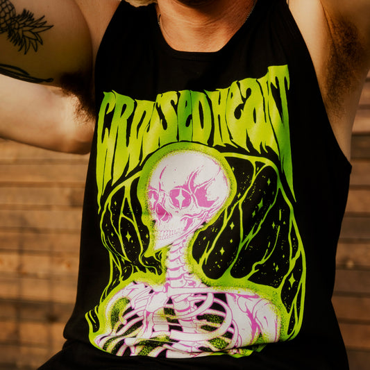 Person wearing black alternative streetwear tank featuring neon green and pink skeleton graphic Alchemist design by Crossed Heart Clothing